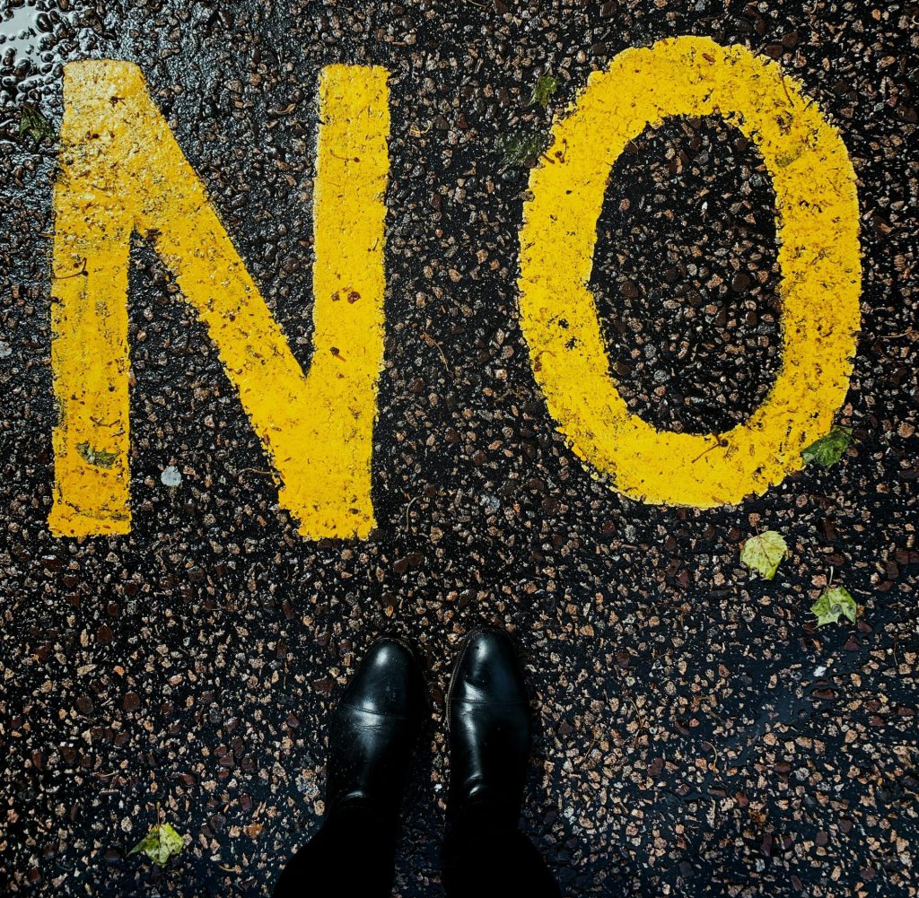 Yellow painted “NO” symbol representing the importance of boundaries and saying no for executive women