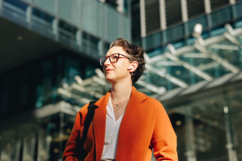 Career Transition Coach Professional woman walking confidently outdoors, representing career transition coaching