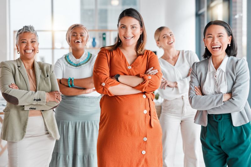Small group of professional women collaborating during an executive group coaching session.